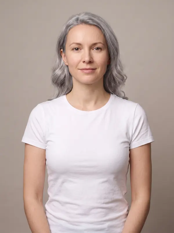Woman with silver gray wavy hair in a white t-shirt